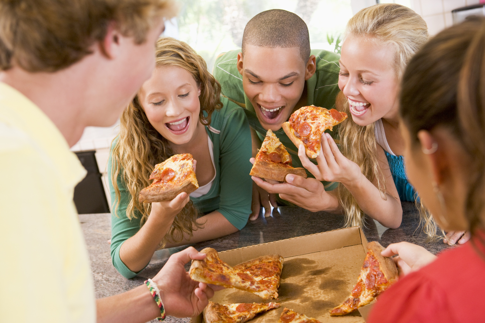 Group of Teenagers Eating Pizza 